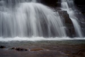Gentle cascade of a waterfall in Idukki, Kerala, India, flowing gracefully over rocks.