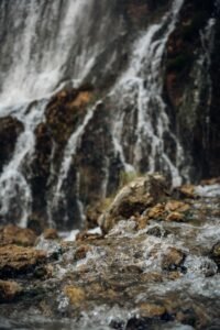 Close-up view of a waterfall cascading over rocks, showcasing natural beauty.