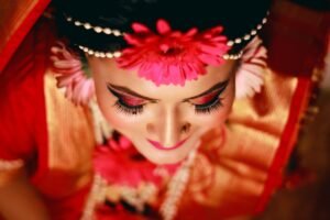 A beautiful Bangladeshi bride wearing traditional attire and vibrant floral ornaments.